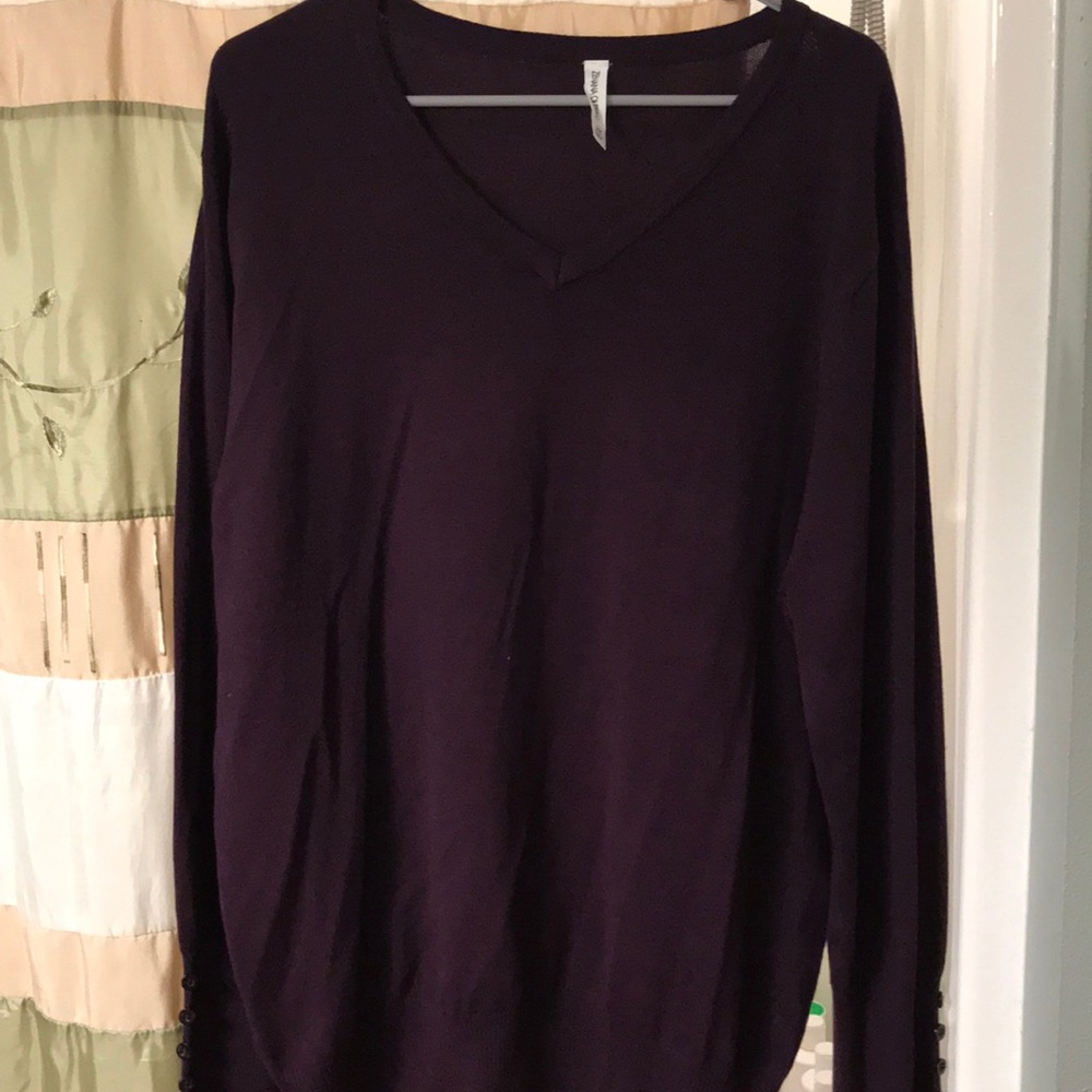 Wine color sweater.